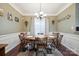 Elegant dining room with wainscoting, chandelier, and natural light at 16337 Greybriar Forest Ln, Charlotte, NC 28278