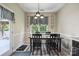 Charming dining room with black wooden table and chairs, decorative walls, and window views at 16337 Greybriar Forest Ln, Charlotte, NC 28278