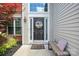 A welcoming front entrance adorned with a decorative wreath and stylish bench at 16337 Greybriar Forest Ln, Charlotte, NC 28278