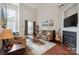 Spacious living room featuring a fireplace, hardwood floors, and natural light at 16337 Greybriar Forest Ln, Charlotte, NC 28278