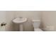A powder room features pedestal sink and white toilet at 18026 Stark Way, Charlotte, NC 28278
