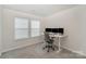 Bedroom with carpeted floor, a window for natural light, and a desk setup for work at 18026 Stark Way, Charlotte, NC 28278