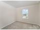 Bright bedroom with a large window offering abundant natural light at 18026 Stark Way, Charlotte, NC 28278