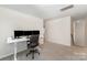 Bedroom with carpeted floor, a window for natural light, and a desk setup for work at 18026 Stark Way, Charlotte, NC 28278