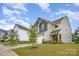 Well-manicured lawns and two-story homes create a welcoming neighborhood atmosphere on a beautiful sunny day at 18026 Stark Way, Charlotte, NC 28278