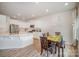 Modern kitchen with white cabinetry, stainless steel appliances, and a dining table at 18026 Stark Way, Charlotte, NC 28278