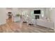 Bright, open living room featuring hardwood floors, a fireplace, and modern furniture at 18026 Stark Way, Charlotte, NC 28278