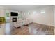 Cozy living room features a fireplace, plush seating, and ample natural light, creating a comfortable atmosphere at 18026 Stark Way, Charlotte, NC 28278