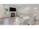 Living room boasts a fireplace, bright windows, and plush seating, perfect for relaxation and entertaining guests at 18026 Stark Way, Charlotte, NC 28278