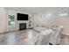 Bright living room featuring hardwood floors, a fireplace, neutral tones and natural light at 18026 Stark Way, Charlotte, NC 28278