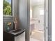Bathroom with mini fridge, tap, grey cabinets, and tiled floors at 18207 Shearer Rd, Davidson, NC 28036