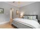 Comfortable bedroom featuring a queen-sized bed, wood floors, a ceiling fan, and neutral decor at 18207 Shearer Rd, Davidson, NC 28036