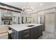 Kitchen island boasts stone countertops, dark cabinetry, gold hardware, and stainless steel appliances at 18207 Shearer Rd, Davidson, NC 28036