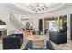 Spacious living room with a fireplace, staircase, and doors leading to an outdoor patio with a pool at 18207 Shearer Rd, Davidson, NC 28036