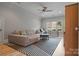 Spacious living room with a large sectional sofa, ceiling fan, and natural light from the window at 18207 Shearer Rd, Davidson, NC 28036
