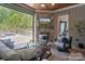Covered outdoor space featuring fireplace, tv, and comfortable seating overlooking a pool at 18207 Shearer Rd, Davidson, NC 28036