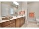 Bathroom features a vanity with wood cabinets, large mirror, and tiled floors at 18311 Rosapenny Rd, Charlotte, NC 28278