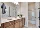 Bathroom featuring a large mirror over vanity with cabinets and a glass-enclosed shower at 18311 Rosapenny Rd, Charlotte, NC 28278