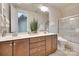 Bathroom with double vanity, granite countertop, wooden cabinets and large mirror at 18311 Rosapenny Rd, Charlotte, NC 28278