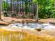 Sandy beach area with chairs in the yard for relaxing by the water at 18311 Rosapenny Rd, Charlotte, NC 28278
