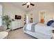 Bedroom with white furniture, ceiling fan, and view to walk-in closet at 18311 Rosapenny Rd, Charlotte, NC 28278