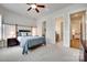 View of bedroom with a four-poster bed leading to bathroom and another room with views of the house at 18311 Rosapenny Rd, Charlotte, NC 28278