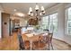 Cozy dining area with a charming table set, ample natural light, and an adjacent kitchen creating a warm and inviting space at 18311 Rosapenny Rd, Charlotte, NC 28278