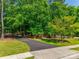 Long driveway through mature trees lead to this lush property at 18311 Rosapenny Rd, Charlotte, NC 28278