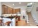 Kitchenette with granite counters, bar seating, wood cabinets and view to carpeted stairs at 18311 Rosapenny Rd, Charlotte, NC 28278