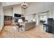 Spacious living room featuring a stone fireplace, hardwood floors, and plenty of natural light streaming through large windows at 18311 Rosapenny Rd, Charlotte, NC 28278