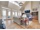 This living room features soaring ceilings, stone fireplace, and French doors leading to outdoor deck at 18311 Rosapenny Rd, Charlotte, NC 28278