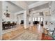 An open-concept living space with hardwood floors, elegant dining set, and fireplace for a warm and inviting ambiance at 18311 Rosapenny Rd, Charlotte, NC 28278
