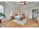 Bright bedroom featuring hardwood floors, a ceiling fan, neutral walls, and ample natural light at 18311 Rosapenny Rd, Charlotte, NC 28278