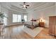 Spacious bedroom features tray ceilings, hardwood floors, sitting area, and large windows at 18311 Rosapenny Rd, Charlotte, NC 28278
