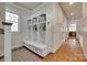 Mudroom with built in shelving, bench, coat hooks, and hardwood flooring at 18311 Rosapenny Rd, Charlotte, NC 28278