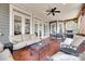 Enjoy the outdoor living on this covered patio with comfortable seating, a ceiling fan, and an outdoor grill at 18311 Rosapenny Rd, Charlotte, NC 28278