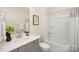 Bright bathroom with a single vanity, white countertop, framed artwork, and shower/tub combo at 2043 Skyhawk Dr, York, SC 29745