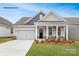 Charming single-Gathering home with a gray exterior, stone accents, attached garage, and well-maintained landscaping at 2043 Skyhawk Dr, York, SC 29745