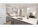 Well-appointed kitchen featuring a center island with seating, stainless steel appliances, and gray cabinets at 2043 Skyhawk Dr, York, SC 29745