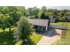 Aerial shot of a home with a well-maintained lawn, mature trees, and a cozy front porch at 205 Wrentree Ln, Gastonia, NC 28056