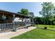 Relaxing back porch with outdoor seating and views of the expansive yard at 205 Wrentree Ln, Gastonia, NC 28056