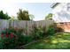 Well-manicured backyard featuring a wooden fence and colorful rose bushes at 205 Wrentree Ln, Gastonia, NC 28056