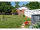 Fenced backyard features well-maintained lawn, partial shade, brick exterior, and a small garden bed at 205 Wrentree Ln, Gastonia, NC 28056