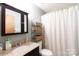 Clean bathroom with a granite countertop vanity and shower with a patterned curtain at 205 Wrentree Ln, Gastonia, NC 28056