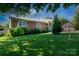 Charming brick home featuring well-maintained lawn and mature landscaping at 205 Wrentree Ln, Gastonia, NC 28056