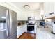 Bright kitchen features stainless steel appliances, white cabinets and granite countertops at 205 Wrentree Ln, Gastonia, NC 28056