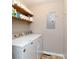 Practical laundry room with Maytag washer/dryer and shelving above for storage at 205 Wrentree Ln, Gastonia, NC 28056