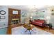 Cozy living room features a brick fireplace, hardwood floors and comfortable seating at 205 Wrentree Ln, Gastonia, NC 28056