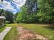 Large backyard with mature trees and a partial fence in a wooded area at 269 Saddle Rd, Lancaster, SC 29720