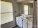 Bathroom featuring a double sink vanity, white cabinets and a window with blinds at 269 Saddle Rd, Lancaster, SC 29720